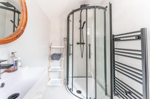 a glass shower in a bathroom with a sink at Modern and Comfy Church Rd Flat 2 with Parking in Newport