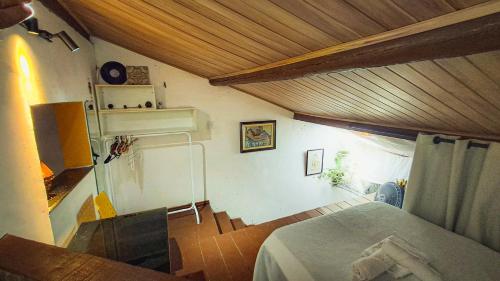 a bedroom with a bed and a wooden ceiling at Casa inteira no Santo Antônio além do Carmo in Salvador