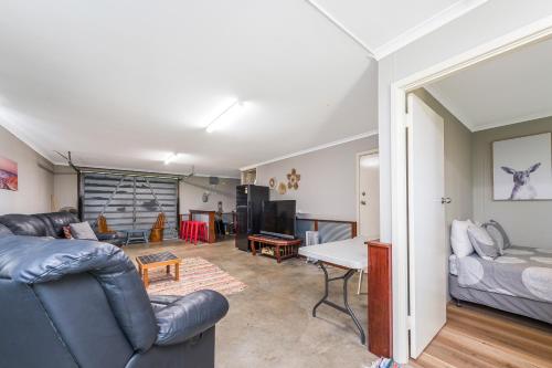 a living room with a couch and a table at Coastal Pine in Guilderton