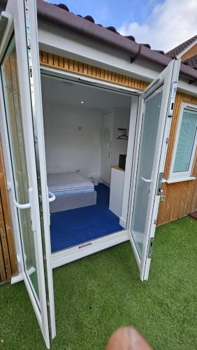 an open door to a room with a bed inside at Restful Place in Wainscot