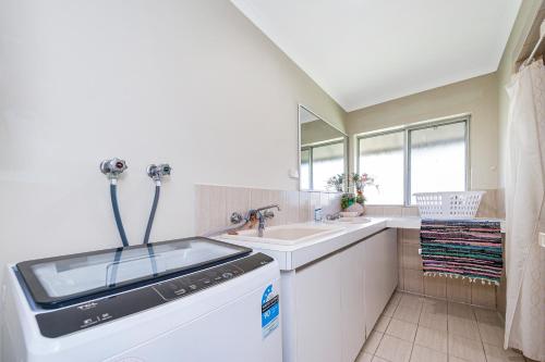a kitchen with a sink and a dishwasher at Coastal Pine in Guilderton