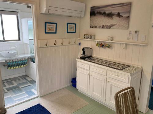 a kitchen with white cabinets and a sink at 93 Atherton in Evergreen