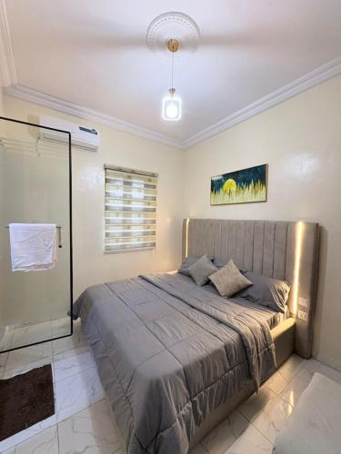 a bedroom with a large bed in a room at MD Homes and Shortlet in Lagos