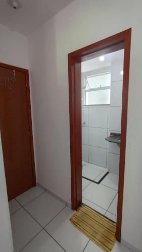 an empty room with a glass door in a room at Quarto privativo in São-José-do-Ribamar