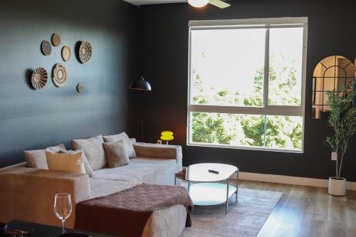 a living room with a couch and a large window at Bright & Cozy Getaway with Pool Free Parking 10 mins Disneyland in Tustin