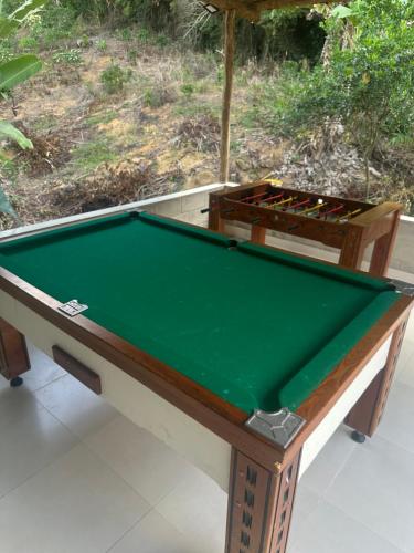 a pool table sitting on top at Pousada Hostels Foryou in Ibiraçu
