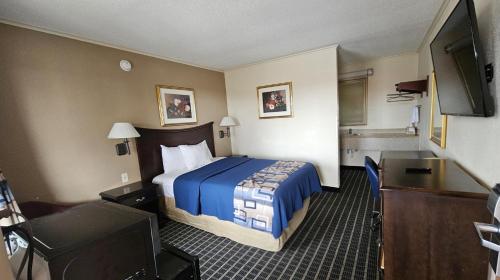 a hotel room with a bed and a flat screen tv at Americas Best Value Inn Mount Vernon in Mount Vernon