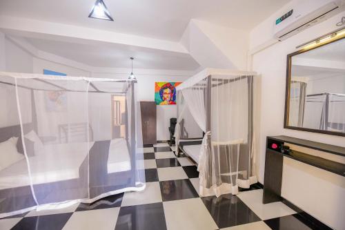 a bathroom with a black and white checkered floor at Villa Kyda - 2 Min walk to the Beaches! in Tangalle