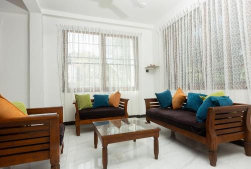 a living room with two couches and a table at Ivy Garden Retreat in Gampola