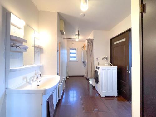 上富良野町にあるNorth Furano Houseの洗面台と洗濯機を備えたバスルーム