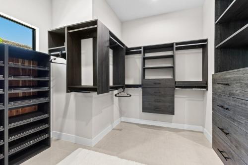 a walk in closet with black and white at Modern Luxury Oasis Pool and Dock in Cape Coral