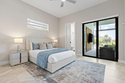 a bedroom with a bed and a large window at Modern Luxury Oasis Pool and Dock in Cape Coral