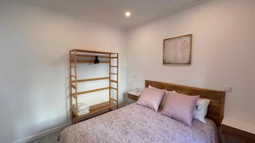 a bedroom with a bed and a mirror on the wall at Charming Baixa VII - 1 Room APT in Lavradio
