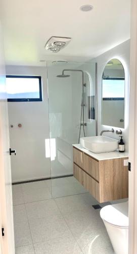 a bathroom with a tub and a sink and a shower at NEW Luxury Cabin with Scenic Views & Farm Charm in Huonville