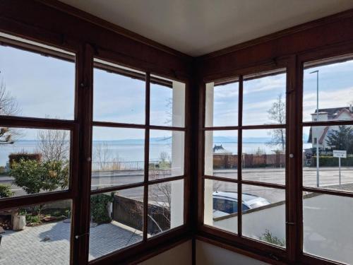 a room with windows with a view of a street at Haus Am See Mühlruh in Horn