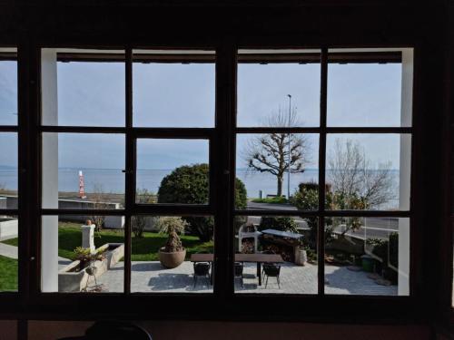 a view through a window of a patio at Haus Am See Mühlruh in Horn