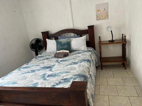 a bedroom with a bed with a stuffed animal on it at El Jardín de Tere in Bijagua