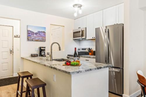 a kitchen with a stainless steel refrigerator and a counter top at Fall Line 107 condo in Telluride