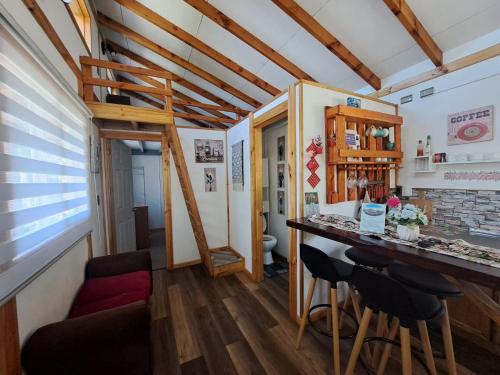 um pequeno quarto com um bar e uma cama suspensa em Cabañas Atardecer Fandango em Chaitén