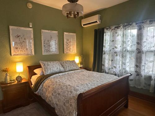 a bedroom with a bed and a window at Private Gated Garden Suite in Historic Home, walk to UNM Football and Basketball, UNM and Pres Hospitals in Albuquerque