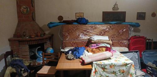 a room with a bed and a table and a fireplace at Margiii apart in Augusta