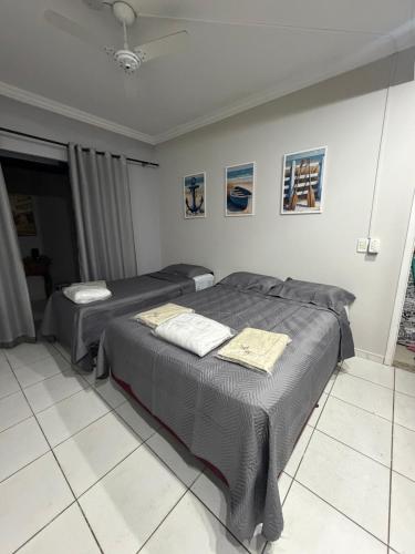 two beds sitting in a room with at Loft BC ESTÚDIO Centro in Balneário Camboriú