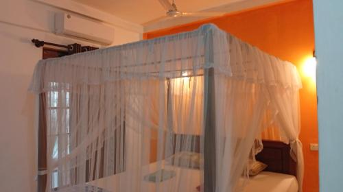 a window with white curtains in a room at Jungle guest ,Mirissa in Mirissa