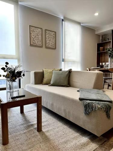 a living room with a couch and a table at Margot Apartments By MrW in Guadalajara