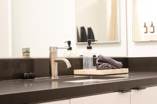 a kitchen counter with a sink with a towel at Pacific Paradise 10 Min from Disneyland With Pool & GYM in Tustin