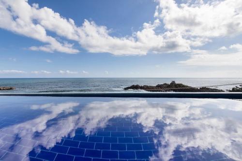 a pool with a view of the ocean and the sky at Yeongdeok Searest Pool Villa in Changsa-ri
