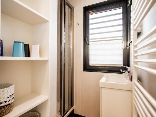 a bathroom with a window and a sink at Spacious HouseBoat in Peenemünde in Peenemünde