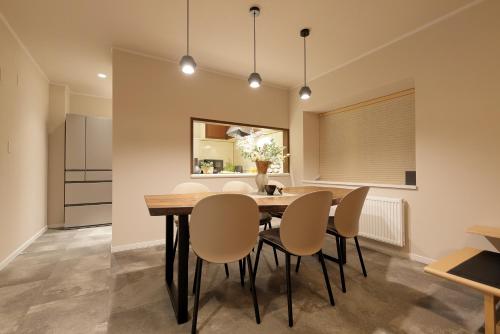 a dining room with a table and chairs at The Crane Sanctuary Sapporo in Sapporo