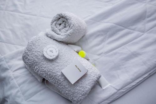 a towel animal is laying on a bed at Kwanskrom Villa Biggies Homes in Winneba