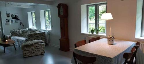 a living room with a table and a couch at Hyggelig Hus Nær Arrild Ferieby in Arrild