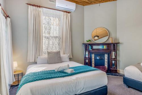 a bedroom with a large bed and a window at Cathedral View - Sleeps 16 in Bendigo