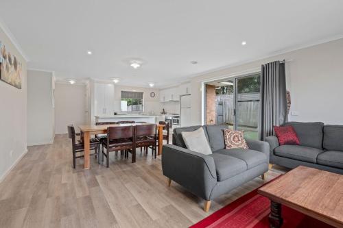 a living room with a couch and a table at Time to Relax in Portarlington