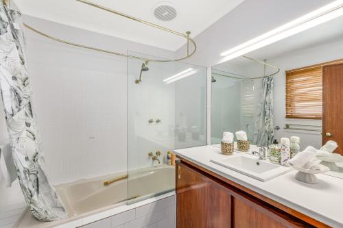 a bathroom with a tub and a sink and a shower at Cathedral View - Sleeps 16 in Bendigo