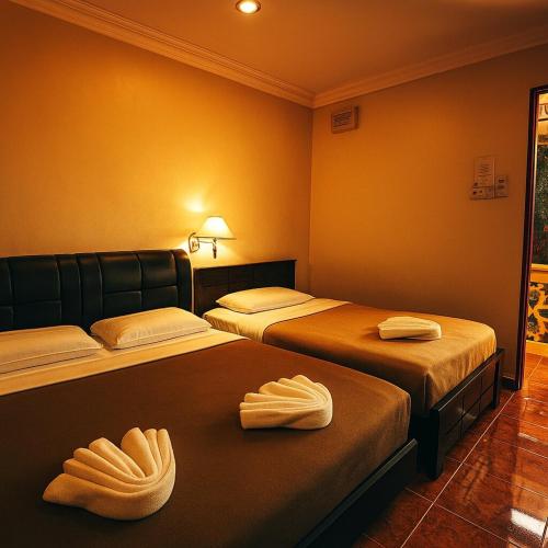 Ένα ή περισσότερα κρεβάτια σε δωμάτιο στο D Teratak Motel