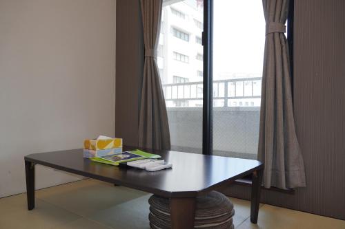 a table with a box on it next to a window at KYU KYU HOTEL in Tokyo