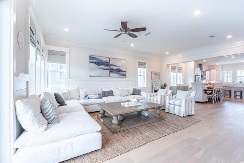 a living room with a white couch and a table at Happily Eva After at Prominence 30A in Inlet Beach