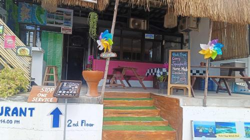a restaurant with signs on the front of a building at The Sunshine hostel and hotel in Ko Lanta