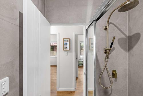 a bathroom with a shower in a room at Inviting Double Room with Sunlit Comfort - Matraville - Shared Bathroom and Kitchen in Sydney