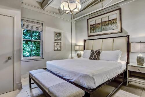 a bedroom with a large white bed and a window at Parker's Collection Unit 8 in Savannah
