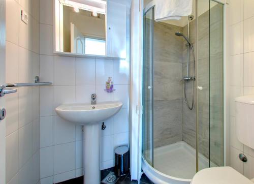 a bathroom with a sink and a shower at Villa Katarina Studio Apartments in Dubrovnik