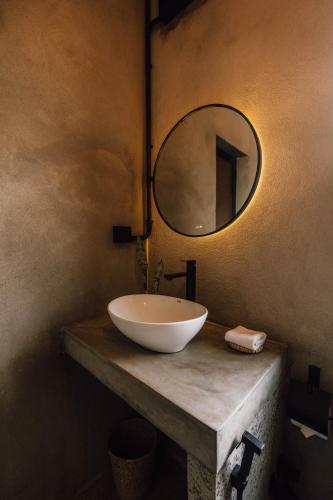 a bathroom with a bowl sink and a mirror at Surfescape Sri Lanka in Midigama East