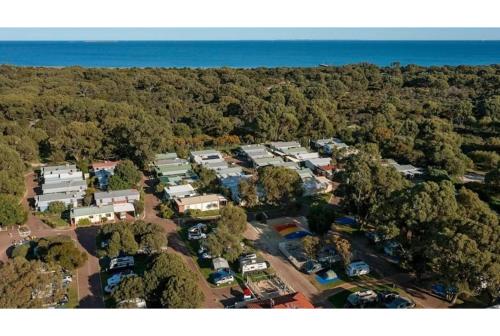 an aerial view of a rv park with trees at Discovery Parks - Woodman Point in Coogee
