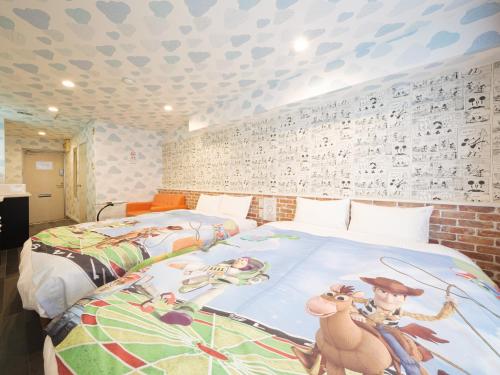 a bedroom with two beds and a wall with hearts at Chiba J-Hotel in Chiba
