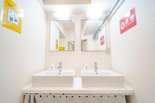 a bathroom with two sinks and a mirror at Higashi-Shinjuku 906 in Tokyo