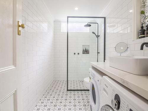 a bathroom with a shower and a sink and a toilet at Healesville Gardener's Cottage in Healesville