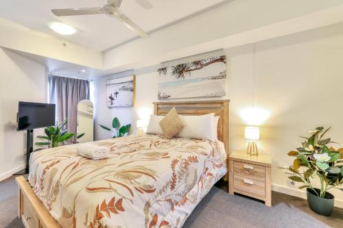 a bedroom with a bed and a flat screen tv at Luxury in Litchfield Street - Heart of the CBD in Darwin